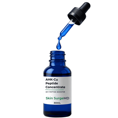 A 30mL blue glass dropper bottle labeled 'AHK-Cu Peptide Booster Liquid Concentrate' by Skin SurgeMD, with a blue liquid dropper cap and a single blue liquid drop hovering above the open bottle against a white background.