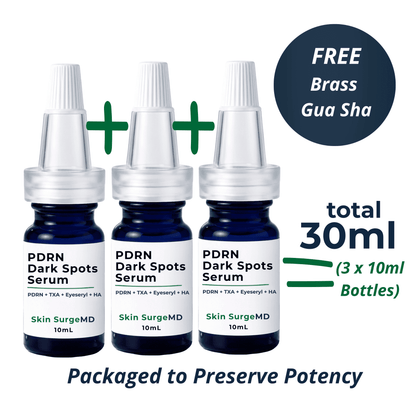 Three small 10ml serum bottles labeled PDRN Dark Spots Serum by Skin SurgeMD are shown on a white background with promotional text. A dark blue circle says FREE Brass Gua Sha, and text indicates total 30ml (3 x 10ml bottles).