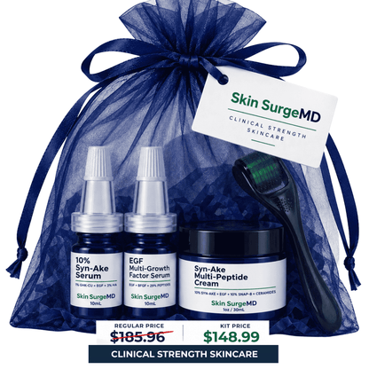 Skin SurgeMD skincare gift set in a navy blue sheer drawstring bag, featuring 10% syn-ake serum, egf serum, and syn-ake multi-peptide cream jar, a black-handled brush, and a white product tag, with a price banner at the bottom.